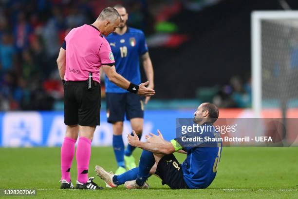Match Referee, Bjoern Kuipers interacts with Giorgio Chiellini of Italy as he goes down after a challenge during the UEFA Euro 2020 Championship...