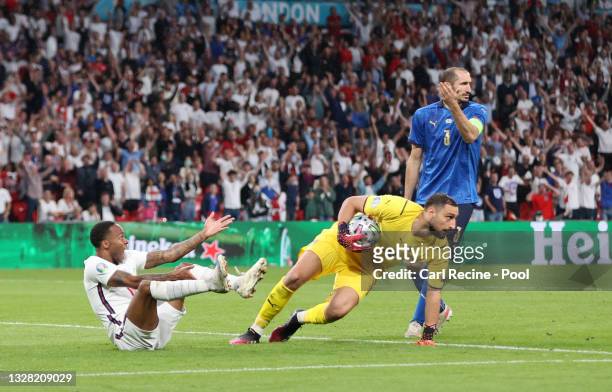 Raheem Sterling of England reacts after being challenged in the box as Gianluigi Donnarumma of Italy collects the ball during the UEFA Euro 2020...