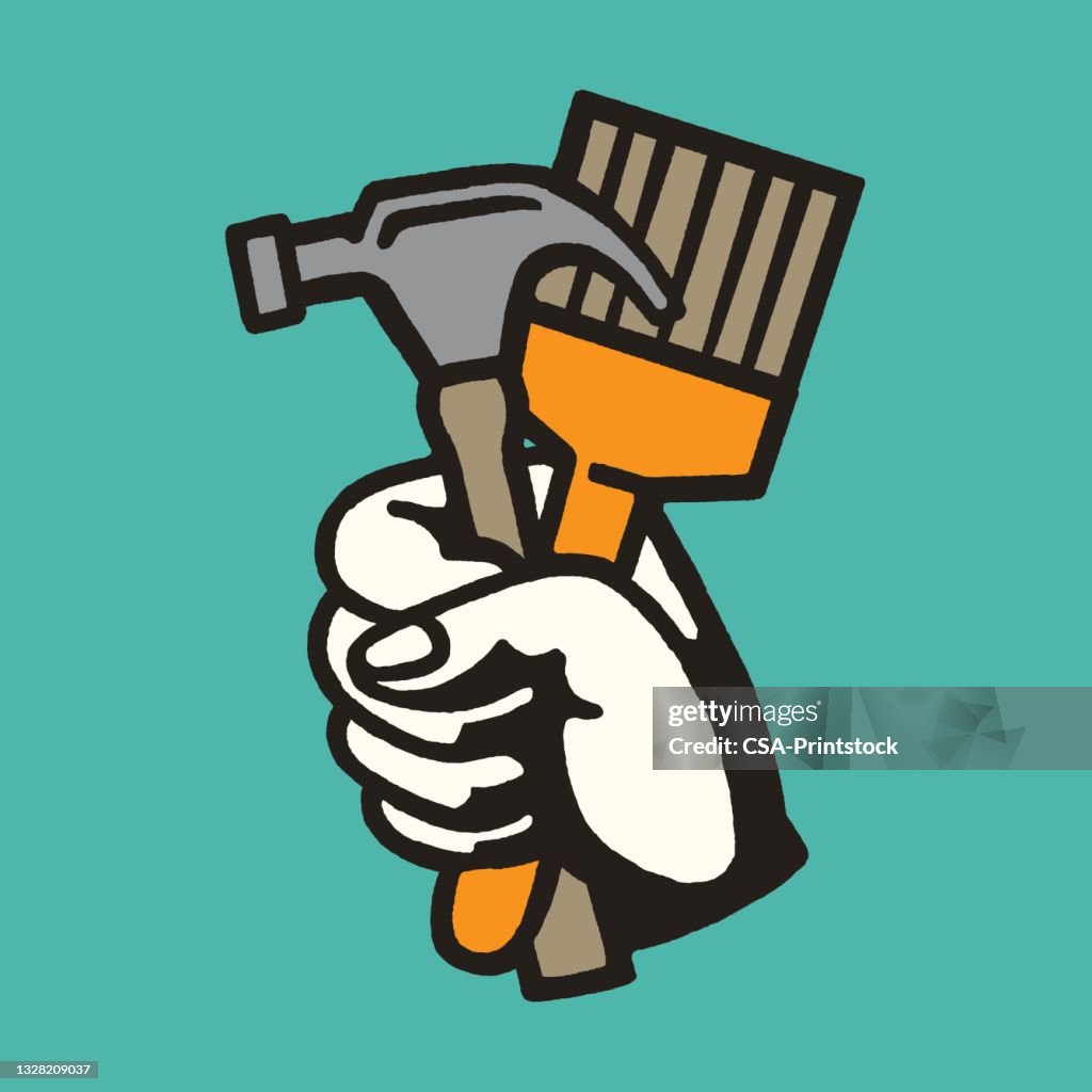 Hand Holding Hammer and Paintbrush