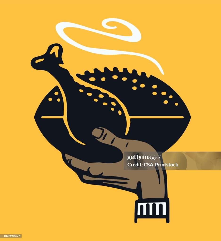 Hand Holding a Football Turkey