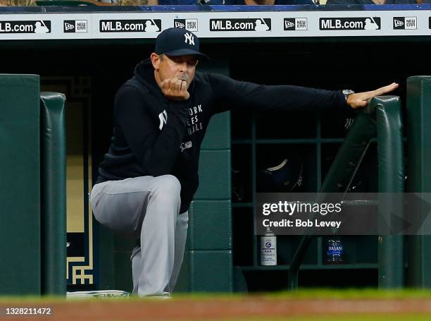 Manager Aaron Boone of the New York Yankees looks on from the dugout against the Houston Astros at Minute Maid Park on July 11, 2021 in Houston,...