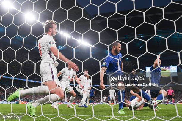Leonardo Bonucci of Italy scores their side's first goal past Jordan Pickford of England as Harry Kane of England looks to block during the UEFA Euro...
