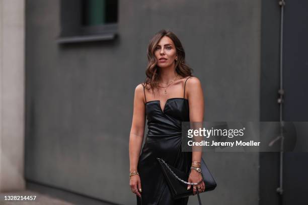 Masha Sedgwick wearing black Nanushka vegan leather dress and black Givenchy bag on July 06, 2021 in Berlin, Germany.