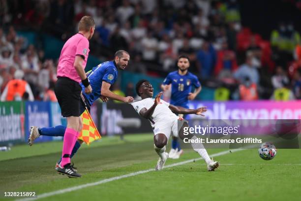 Bukayo Saka of England is fouled by Giorgio Chiellini of Italy during the UEFA Euro 2020 Championship Final between Italy and England at Wembley...