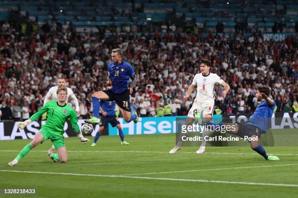 Federico Bernardeschi of Italy is challenged by Jordan Pickford of England during the UEFA Euro 2020 Championship Final between Italy and England at...