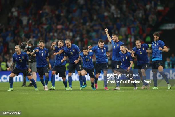 Italy players celebrate victory as Gianluigi Donnarumma of Italy saves the England fifth penalty taken by Bukayo Saka of England following the UEFA...
