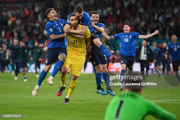 Jordan Pickford of England looks on dejected as Giovanni Di Lorenzo, Gianluigi Donnarumma, Andrea Belotti, and Alessandro Florenzi of Italy celebrate...