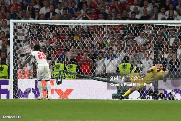 Bukayo Saka of England misses his team's fifth penalty in a penalty shoot out which is saved by Gianluigi Donnarumma of Italy during the penalty...