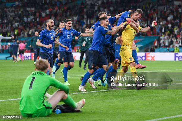 Gianluigi Donnarumma of Italy celebrates with teammates after saving the England fifth penalty taken by Bukayo Saka of England in a penalty shoot out...