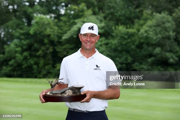 Lucas Glover poses with the trophy after his win in the final round of the John Deere Classic at TPC Deere Run on July 11, 2021 in Silvis, Illinois.