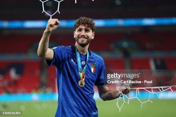 Manuel Locatelli of Italy cuts the net following victory in the UEFA Euro 2020 Championship Final between Italy and England at Wembley Stadium on...