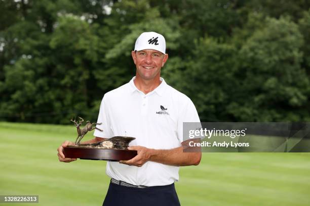 Lucas Glover poses with the trophy after his win in the final round of the John Deere Classic at TPC Deere Run on July 11, 2021 in Silvis, Illinois.