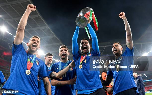 Leonardo Spinazzola of Italy celebrates with The Henri Delaunay Trophy following his team's victory in the UEFA Euro 2020 Championship Final between...