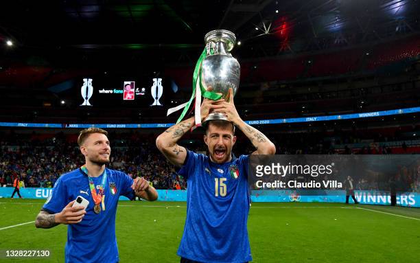 Francesco Acerbi of Italy celebrates with The Henri Delaunay Trophy following his team's victory in the UEFA Euro 2020 Championship Final between...