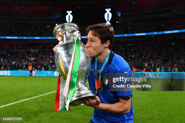 Federico Chiesa of Italy kisses The Henri Delaunay Trophy following his team's victory in the UEFA Euro 2020 Championship Final between Italy and...