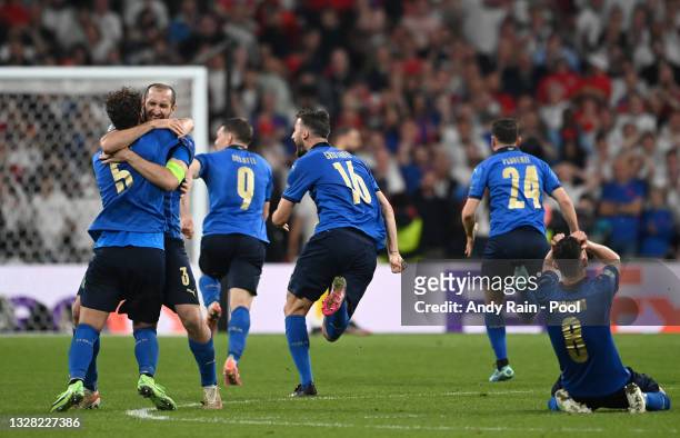 Giorgio Chiellini, Manuel Locatelli and Jorginho of Italy celebrate after victory in the UEFA Euro 2020 Championship Final between Italy and England...
