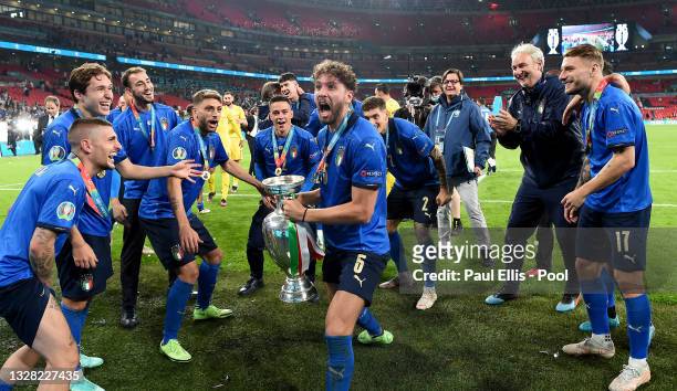 Manuel Locatelli of Italy celebrates with The Henri Delaunay Trophy following his team's victory in the UEFA Euro 2020 Championship Final between...