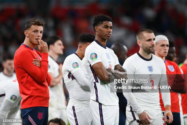 Ben White, Marcus Rashford and Luke Shaw of England look dejected following their team's defeat in the UEFA Euro 2020 Championship Final between...