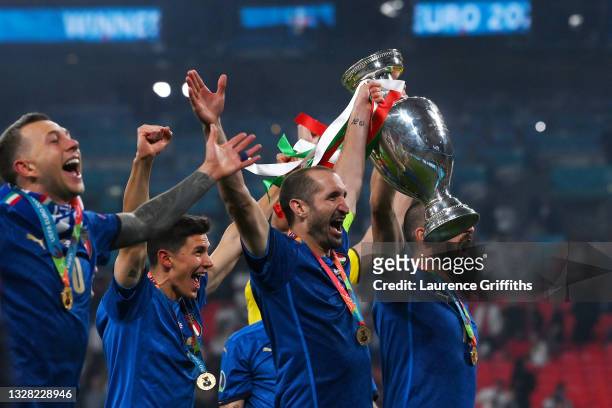 Giorgio Chiellini of Italy celebrates with The Henri Delaunay Trophy following his team's victory in the UEFA Euro 2020 Championship Final between...