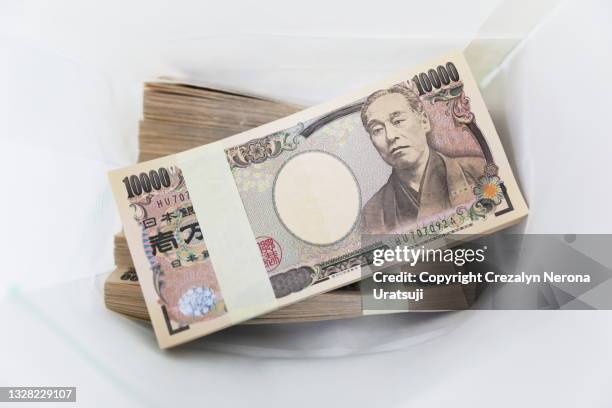 i million yen japanese money in white paper bag  currency of japan - japanese currency stock pictures, royalty-free photos & images