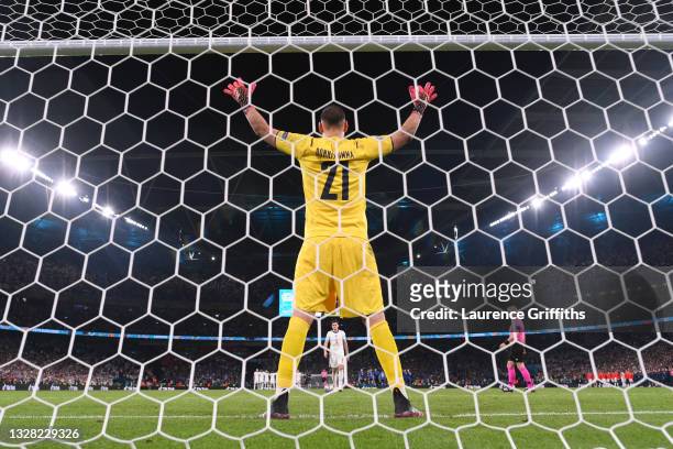 Harry Maguire of England walks up to take his penalty as in a penalty shoot out as Gianluigi Donnarumma of Italy looks on during the UEFA Euro 2020...