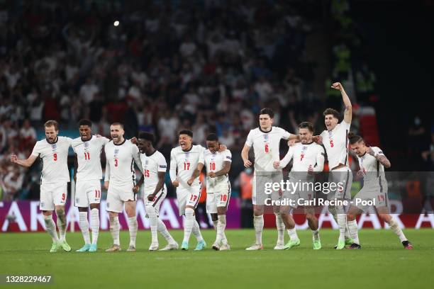 Players of England celebrate after the Italy second penalty is saved by Jordan Pickford of England during the UEFA Euro 2020 Championship Final...