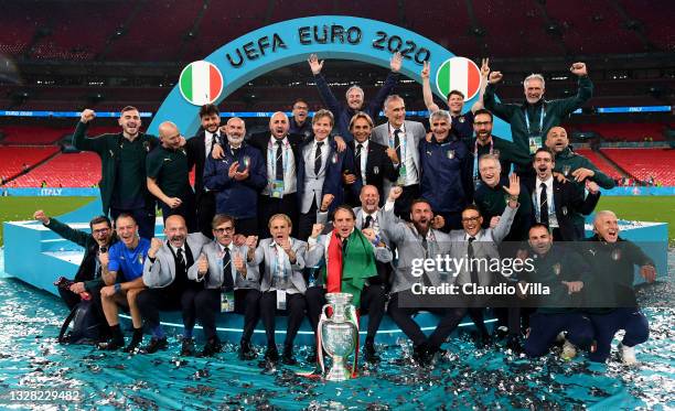 Roberto Mancini, Head Coach of Italy and the backroom staff celebrate with The Henri Delaunay Trophy following his team's victory in the UEFA Euro...