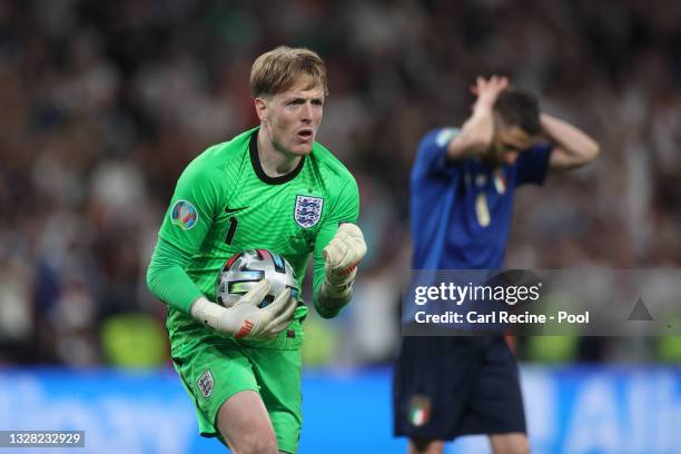 Jordan Pickford of England celebrates after saving Italy's fifth penalty from Jorginho of Italy during the UEFA Euro 2020 Championship Final between...