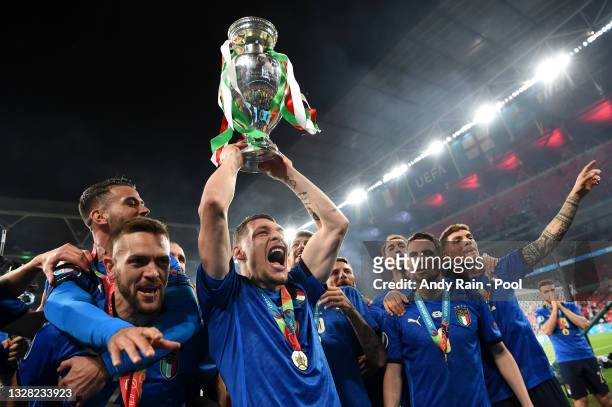 Leonardo Spinazzola, Rafael Toloi, Andrea Belotti and Jorginho of Italy celebrate with The Henri Delaunay Trophy following their team's victory in...