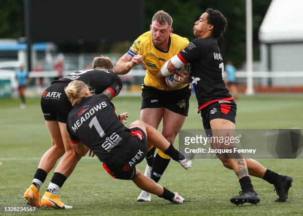 Danny Kirmond of York City Knights is tackled by James Meadows, Joshua Walters and Chris Hankinson of London Broncos during the Betfred Championship...