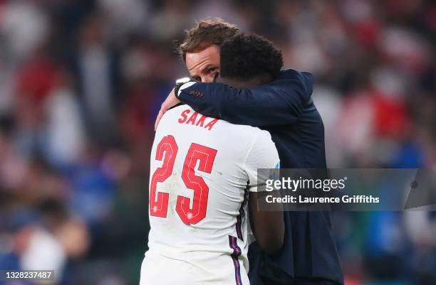 Bukayo Saka of England is consoled by Gareth Southgate, Head Coach of England following defeat in the UEFA Euro 2020 Championship Final between Italy...