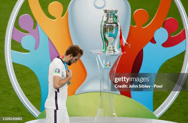 Harry Kane of England walks past the Henri Delaunay Trophy following his team's defeat in the UEFA Euro 2020 Championship Final between Italy and...