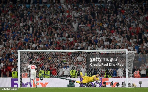 Bukayo Saka of England misses his team's sixth penalty in a penalty shoot out which is saved by Gianluigi Donnarumma of Italy during the penalty...