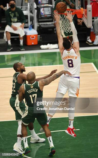 Frank Kaminsky of the Phoenix Suns goes up for a dunk over Khris Middleton and P.J. Tucker of the Milwaukee Bucks during the first half in Game Three...