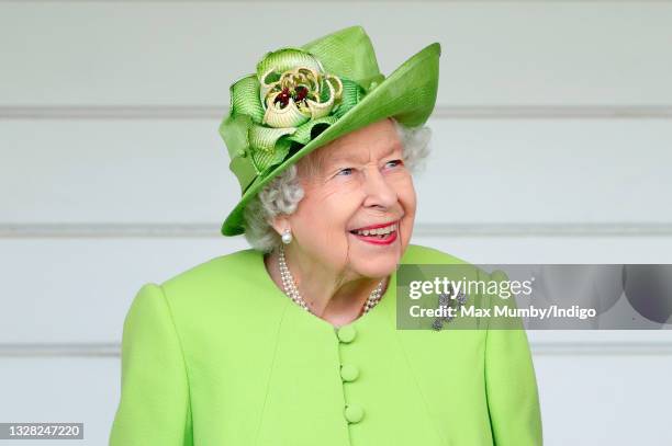 Queen Elizabeth II attends the Out-Sourcing Inc. Royal Windsor Cup polo match and a carriage driving display by the British Driving Society at Guards...