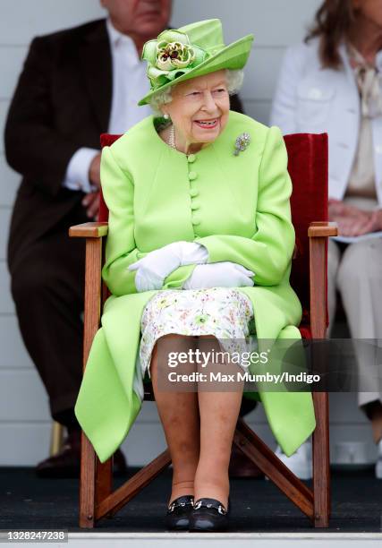 Queen Elizabeth II attends the Out-Sourcing Inc. Royal Windsor Cup polo match and a carriage driving display by the British Driving Society at Guards...