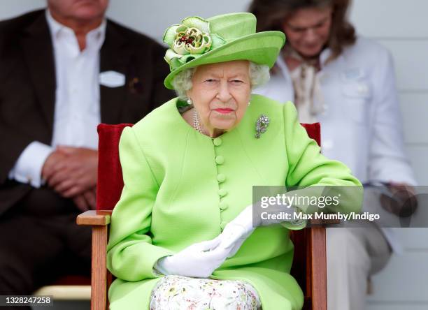 Queen Elizabeth II attends the Out-Sourcing Inc. Royal Windsor Cup polo match and a carriage driving display by the British Driving Society at Guards...