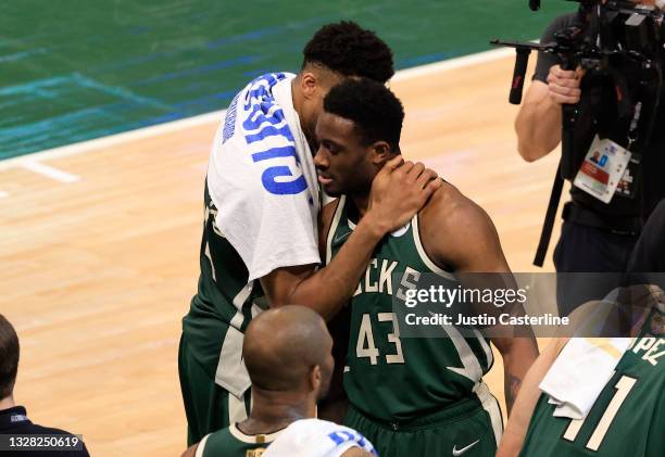 Giannis Antetokounmpo and his brother Thanasis Antetokounmpo of the Milwaukee Bucks celebrate their victory over the Phoenix Suns in Game Three of...