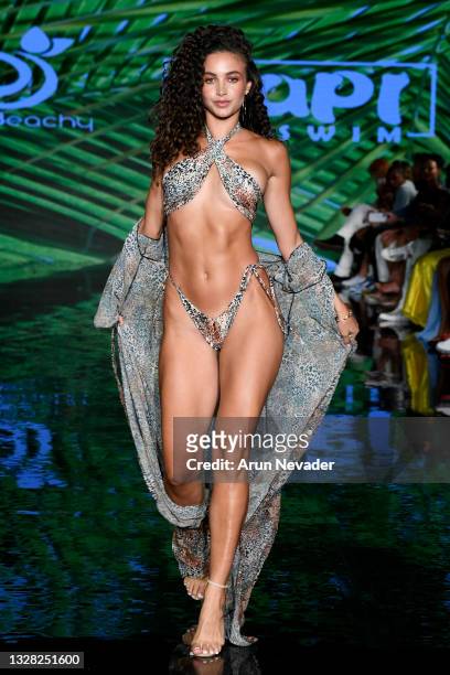 Model walks the runway at the BERRY BEACHY & PAPI SWIM Show during Miami Swim Week Powered By Art Hearts Fashion at Faena Forum on July 11, 2021 in...