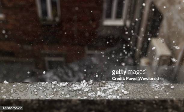 hail smashing on window sill - hailstorm stock pictures, royalty-free photos & images