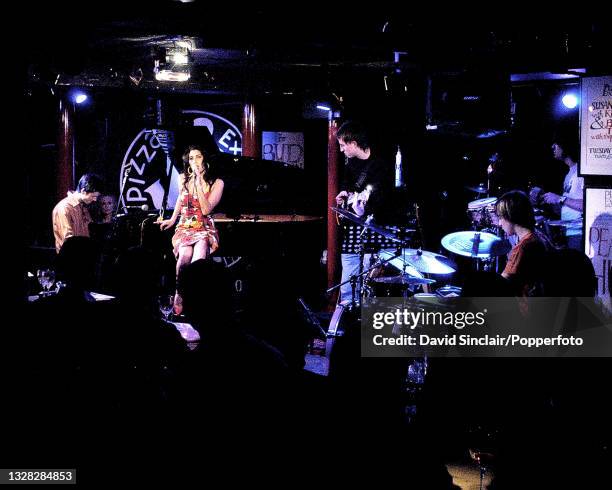 English singer Amy Winehouse performs live on stage with the Bradley Webb Trio at PizzaExpress Jazz Club in Soho, London on 6th March 2004.