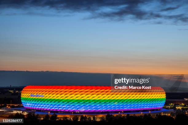 General view outside Allianz Arena which is illuminated in rainbow colours for Christopher Street Day on July 10, 2021 in Munich, Germany....