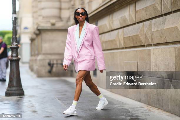 Emilie Joseph @in_fashionwetrust wears bblack sunglasses, a double white and pink blazer jacket dress from Frankieshop, a silver and diamond earrings...