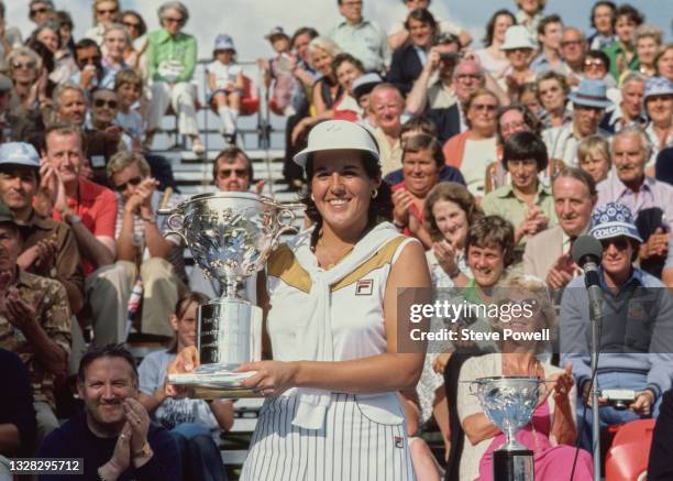 Nancy Lopez of the United States holds the champion golfer trophy after winning the Colgate European Women's Open golf tournament on 5th August 1979...