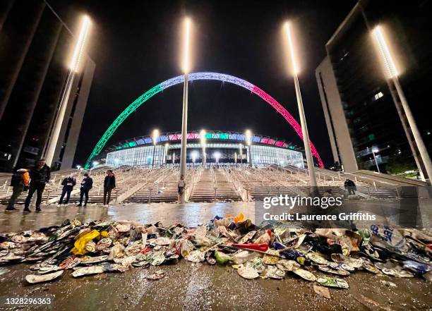 The Wembley Arch is illuminated in the colours of the Italian flag as rubbish is seen outside the stadium after the UEFA Euro 2020 Championship Final...