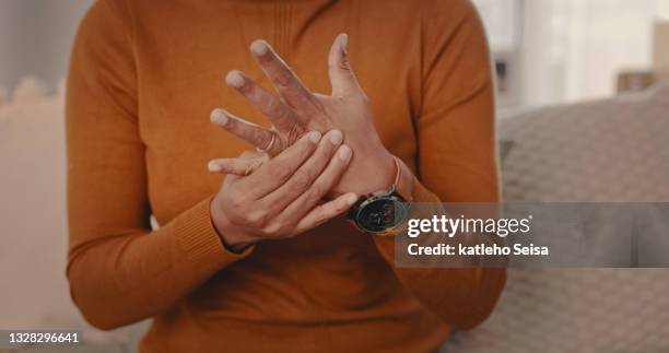 shot of an unrecognizable person sitting on the couch while touching their hands at home - finger ring stock pictures, royalty-free photos & images