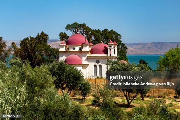 the church of the holy apostles with view of the sea of galilee, capernaum, israel - capernaum stock pictures, royalty-free photos & images