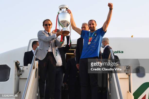 Coach Roberto Mancini and captain Giorgio Chiellini lift The Henri Delaunay Trophy after travelling back to Rome following the Euro 2020 victory on...