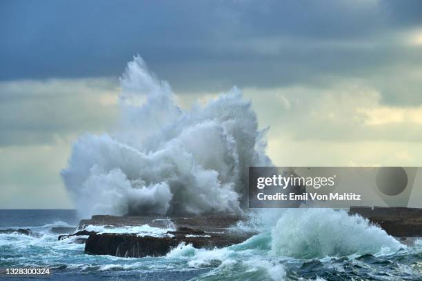 waves breaking against a coastal rocl shelf, luphathana, eastern cape, south africa - wild coast stock pictures, royalty-free photos & images