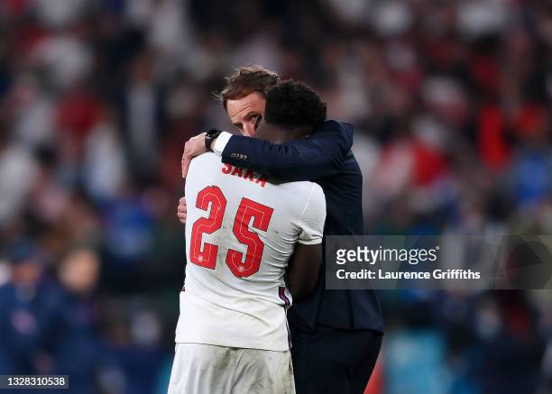 Bukayo Saka of England is consoled by Head Coach, Gareth Southgate after his penalty miss during the UEFA Euro 2020 Championship Final between Italy...
